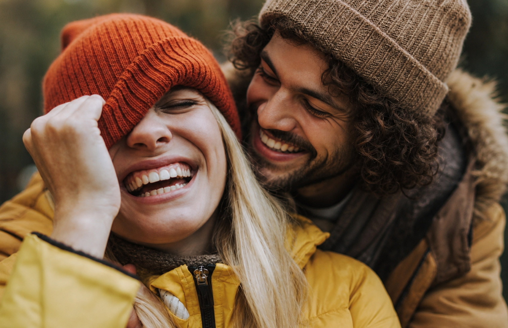 Smiling Couple Wearing Winter Beanies, Front-Facing View