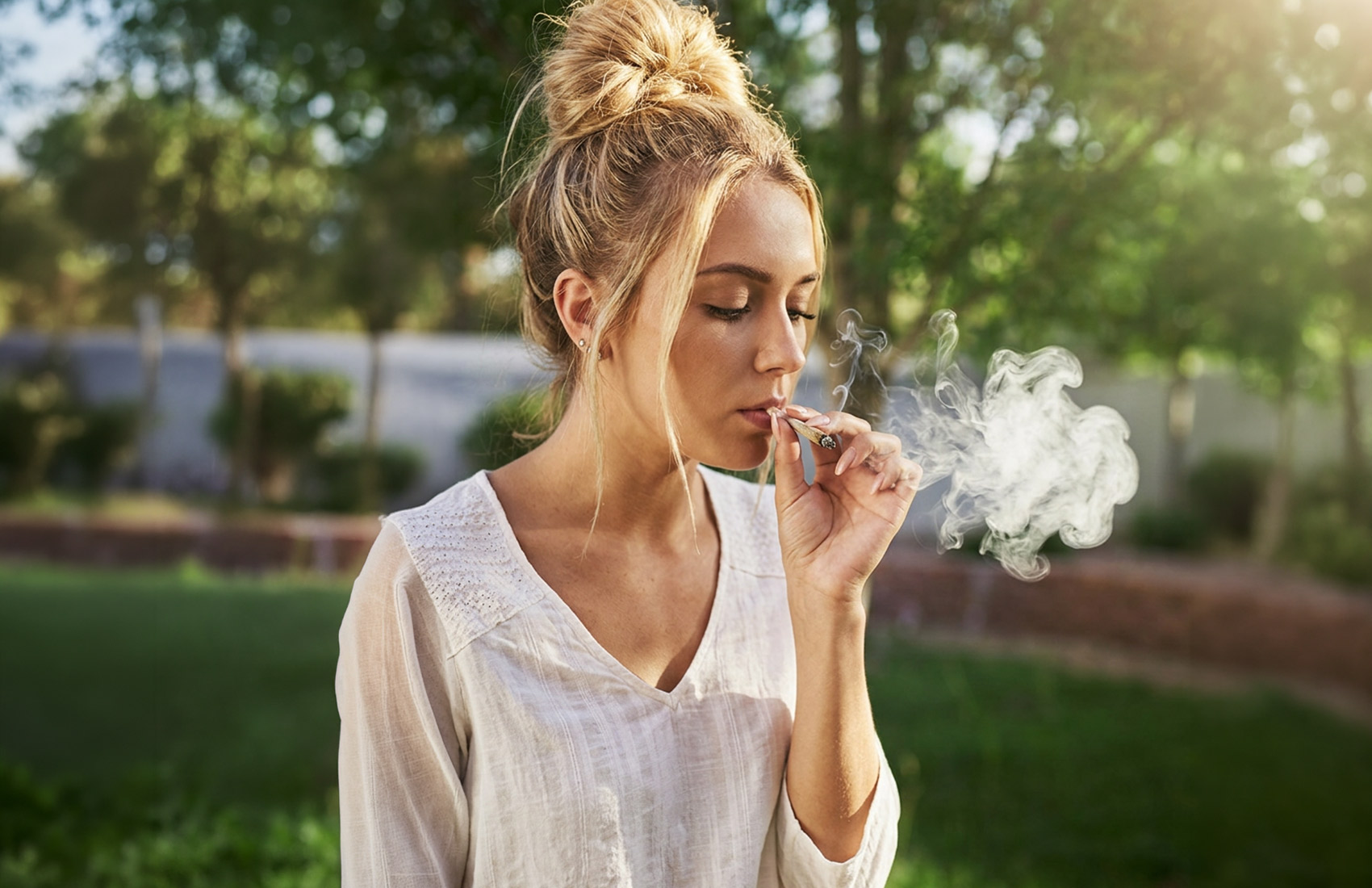 Blonde Woman In White Shirt Smoking, Side View
